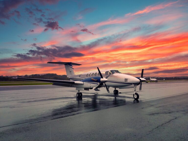 Beechcraft King Air turboprop on a wet ramp at sunset