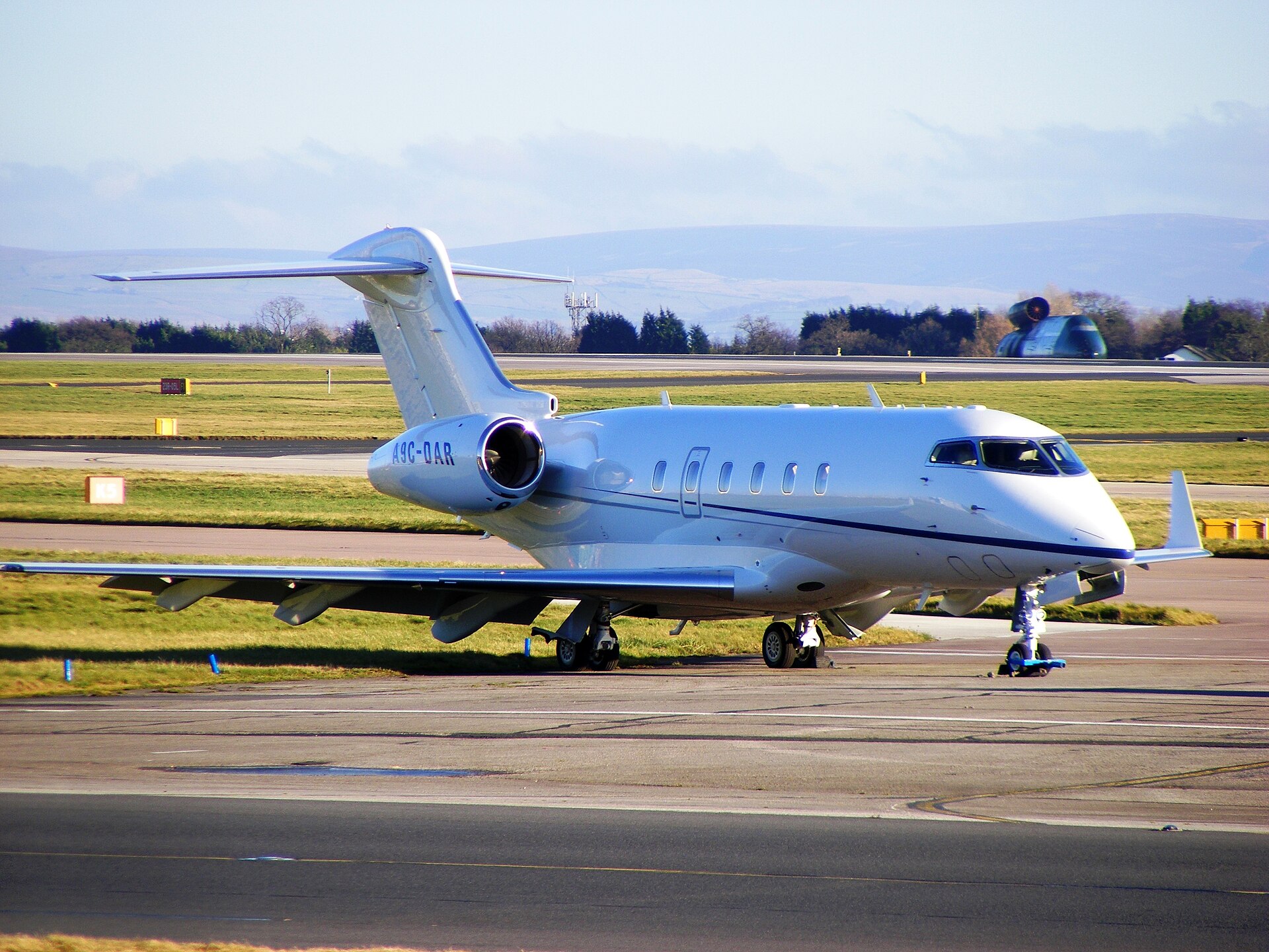 Bombardier Challenger 300 super midsize jet parked on the airport ramp